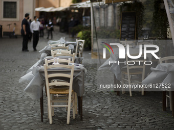   Wind moves the tablecloths of the tables of a deserted restaurant in Trastevere district as Italy is facing a surge in the coronavirus dis...