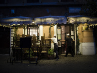    Staffers close a restaurant in Trastevere district as Italy is facing a surge in the coronavirus disease (COVID-19) infections in Rome, I...