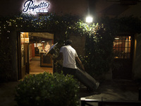    Staffers close a restaurant in Trastevere district as Italy is facing a surge in the coronavirus disease (COVID-19) infections in Rome, I...