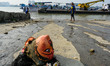 A head of an idol pulled out of the water after immersion rests at a river bank in Kolkata...