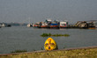 A head of an idol pulled out of the water after immersion rests at a river bank in Kolkata...