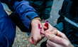 A woman is painting the red symbol of the protests against abortion ban In Poland before a...