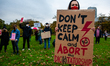 A woman is holding a big placard, during the protest against the abortion ban In Poland, t...