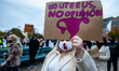 A woman is holding a placard with an uterus drawn on it, during the protest against the ab...
