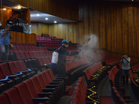 A worker sprays disinfectant solution as precautionary measure  inside of the Hidalgo theater. Has been allowed resumption of Mexico City's...