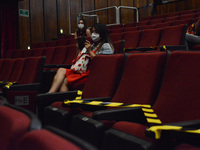 A woman wears face mask  while waits for the show  maintaining social distancing at  the Hidalgo theater. has been allowed resumption of Mex...