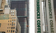 A store front of a Starbucks Coffee shop located in Midtown Manhattan with people walking...