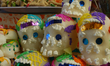 Sugar Skulls are seen in  outdoor market, sugar skulls are used as ornaments in offerings...