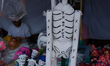 Cardboard skulls are seen in  outdoor market, Cardboard skulls are used as ornaments in of...