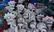 Cardboard skulls are seen in  outdoor market, Cardboard skulls are used as ornaments in of...