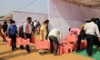 Election officials leave for their respective polling stations after collecting Electronic...