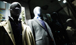 A face mask covers the head of a mannequin in the window of a temporarily closed branch of...