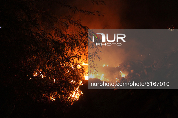 Smoke rising from a fire in shrubs in the forest near DND flyway fills the air, on November 7, 2020 in New Delhi, India. Delhi's Air Quality...