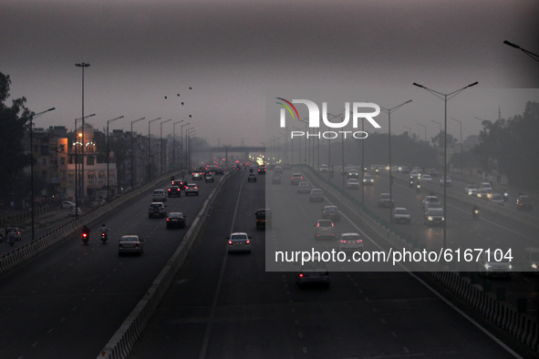 Vehicular traffic passing through amid a layer of smoky haze, as the air quality hit 'severe' levels due to stubble burning from the adjoini...