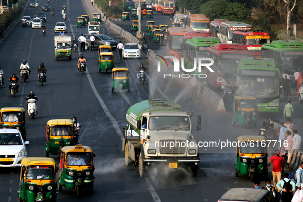 An EDMC truck sprinkles water on the road to curb pollution, at Anand Vihar, on November 7, 2020 in New Delhi, India. Delhi's Air Quality In...