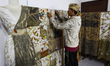 A worker is seen arranging a leaf-patterned cloth for sale at the Arae production gallery,...