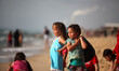 Palestinians enjoy a day at the beach of the Mediterranean Sea on the coast of Gaza City,...
