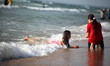 Palestinians enjoy a day at the beach of the Mediterranean Sea on the coast of Gaza City,...