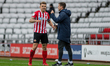  Max Power celebrates with Andrew Taylor, first team coach after scoring his sides first g...
