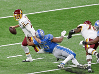 Washington Football Team quarterback Alex Smith (11) is sacked by Detroit Lions defensive end Romeo Okwara (95) during the first half of an...