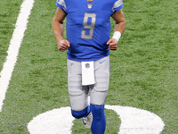 Quarterback Matthew Stafford (9) of the Detroit Lions runs off the field after the cointoss during the first half of an NFL football game be...