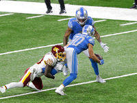 Detroit Lions wide receiver Danny Amendola (80) is tackled by Washington Football Team cornerback Jimmy Moreland (20) as he passes the ball...
