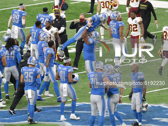 Detroit Lions kicker Matt Prater (5) celebrates with Detroit Lions offensive tackle Tyrell Crosby (65) after making the field goal for a 30-...