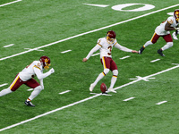 Kicker Dustin Hopkins (3) of the Washington Football Team kicks to the Lions during the second half of an NFL football game between the Wash...
