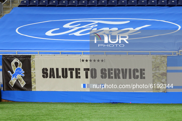 Signs in honor of military personnel are displayed on the sidelines of Ford Field during the first half of an NFL football game between the...