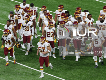 Players on the Washington Football Team run on the field ahead of the first half of an NFL football game between the Washington Football Tea...