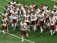 Players on the Washington Football Team run on the field ahead of the first half of an NFL football game between the Washington Football Tea...