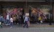 A large number of people are waiting in line to enter a department store in the Zócalo of...
