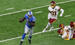Running back Adrian Peterson (28) of the Detroit Lions carries the ball under the pressure...