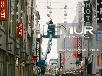 Workers install the traditional christmas light in city center of Cologne, on November 19, 2020.  (