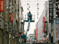Workers install the traditional christmas light in city center of Cologne, on November 19, 2020.  (