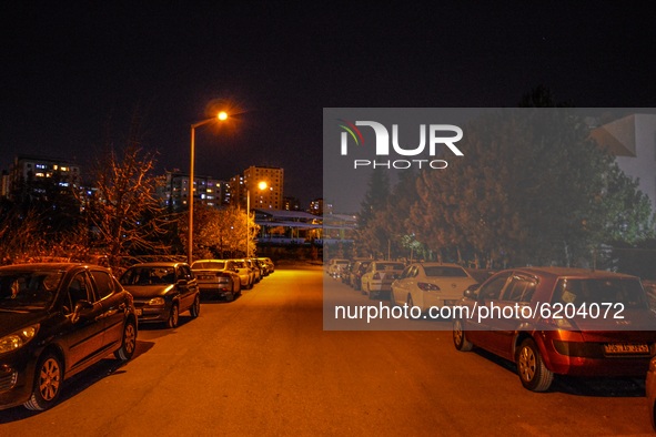 Vehicles are parked outside an apartment building during the start of a fourteen-hour partial weekend curfew amid the coronavirus (COVID-19)...
