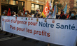 Nurses keep a banner reading 'An urgency plan for the hospital, not for the profits'. Thou...