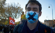 A protester has put a black cross on his mouth to symbolize the "Blobal Security Law' bill...