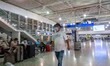 Passengers seen with the obligatory face masks at the main departure hall in the terminal...