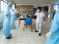 Sri Lankan Health workers in  protective suits get sprayed with disinfectants  after taking swabs from people at Colombo, Sri Lanka. Monday...