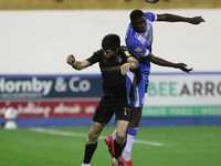 Bobby Grant of Oldham Athletic contests a header with Yoan Zouma of Barrow during the Sky Bet League 2 match between Barrow and Oldham Athle...