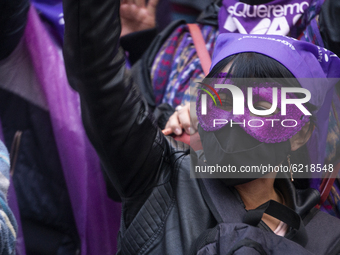 A woman with a mask participate in the Day of non-violence against women in Bogota, Colombia, on November 25, 2020 (