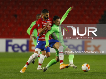 Marinos Tzioni, of AC Omonoia and Maxime Gonalons, of Granada CF  during the UEFA Europa League Group E stage match between Granada CF and A...