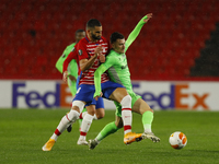 Marinos Tzioni, of AC Omonoia and Maxime Gonalons, of Granada CF  during the UEFA Europa League Group E stage match between Granada CF and A...