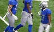 Detroit Lions running back Adrian Peterson (28) is congratulated by Detroit Lions wide rec...
