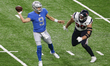 Detroit Lions quarterback Matthew Stafford (9) passes the ball under the pressure of Houst...