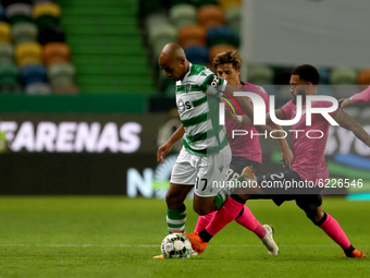 Joao Mario of Sporting CP (L) vies with Anthony DAlberto of Moreirense FC during the Portuguese League football match between Sporting CP an...