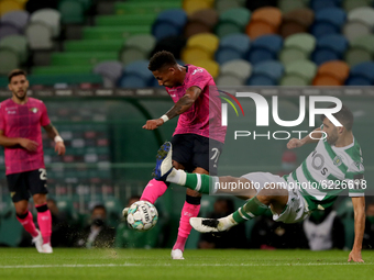 Walterson Silva of Moreirense FC (C ) vies with Luis Neto of Sporting CP during the Portuguese League football match between Sporting CP and...
