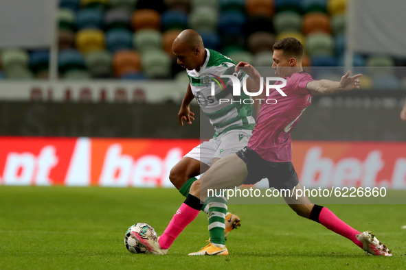 Joao Mario of Sporting CP (L) vies with Alex Soares of Moreirense FC during the Portuguese League football match between Sporting CP and Mor...