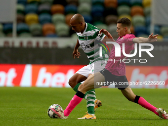 Joao Mario of Sporting CP (L) vies with Alex Soares of Moreirense FC during the Portuguese League football match between Sporting CP and Mor...